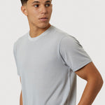 Man wearing a light gray t-shirt against a plain background