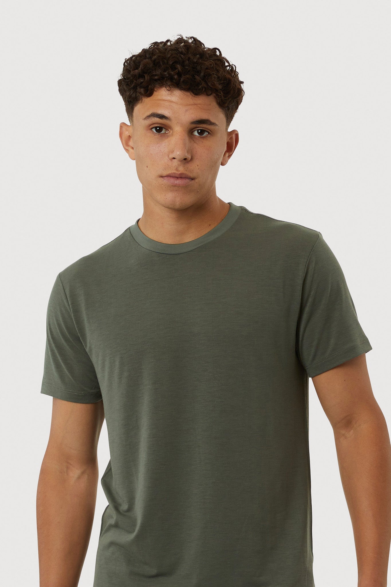 Man wearing a green t-shirt against a white background