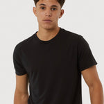 Person wearing a black t-shirt against a white background