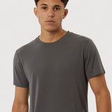 Man wearing a gray t-shirt against a white background