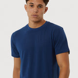 Man wearing a blue t-shirt against a white background