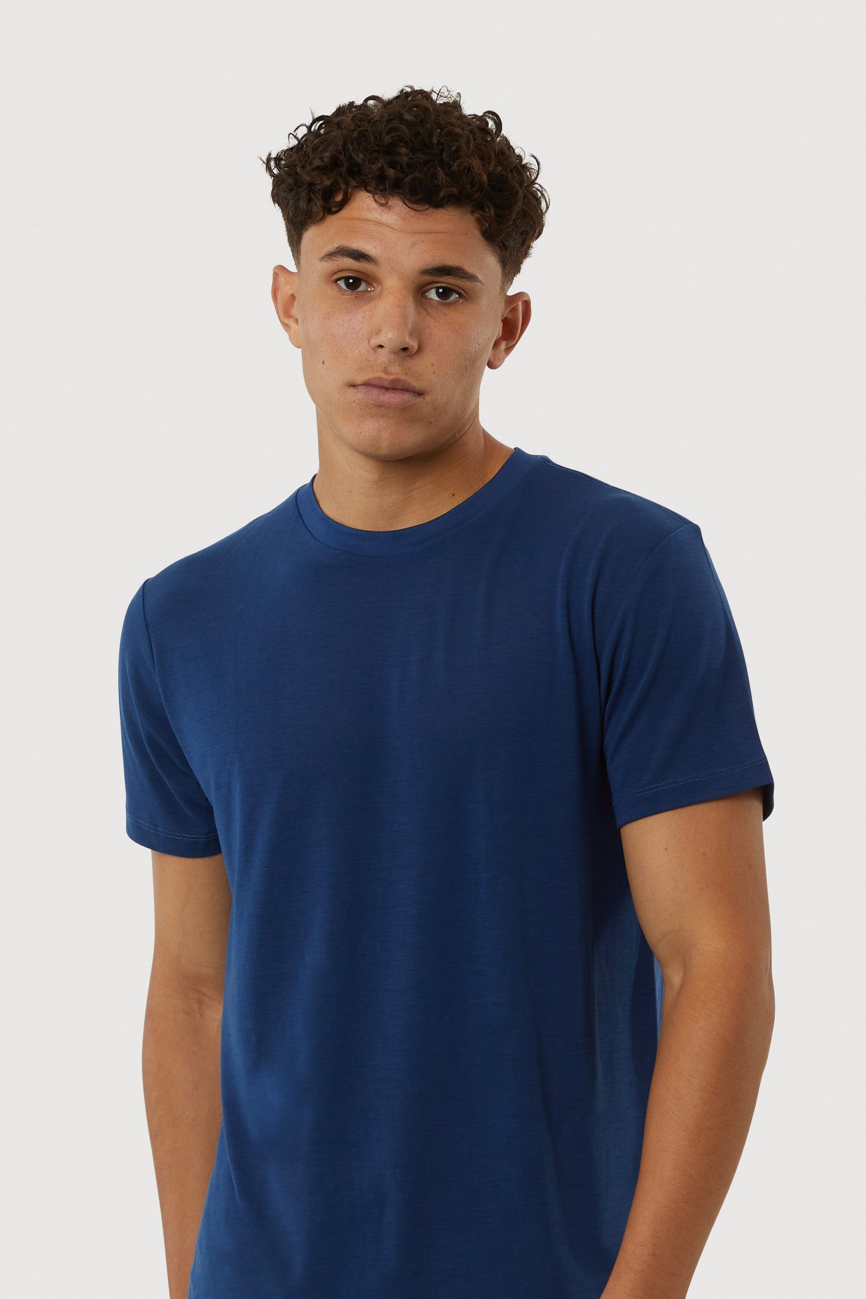Man wearing a blue t-shirt against a white background