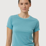 Woman wearing a blue t-shirt against a light gray background