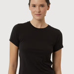 Woman wearing a black t-shirt against a plain background