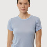 Woman wearing a light blue t-shirt against a plain background