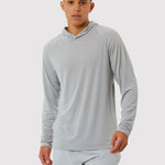 Person wearing a gray long-sleeve shirt and shorts on a white background