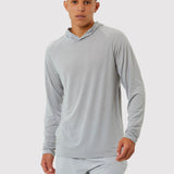 Person wearing a gray long-sleeve shirt and shorts on a white background