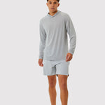 Man wearing a gray long-sleeve shirt and shorts on a white background