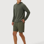 Man wearing a green athletic outfit on a white background