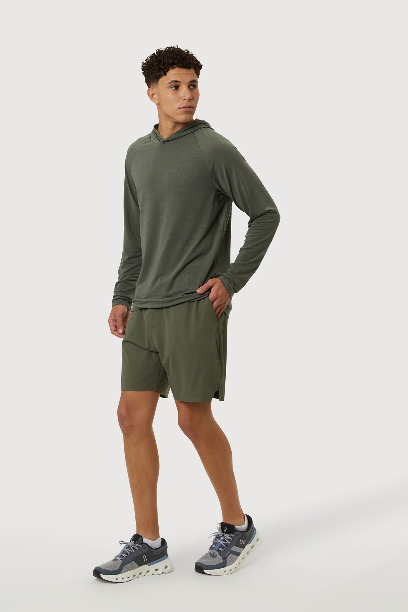 Man wearing a green athletic outfit on a white background