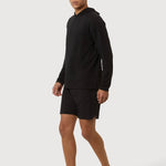 Person wearing a black long-sleeve shirt and shorts on a white background