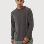 Man wearing a gray long-sleeve athletic shirt and shorts on a white background