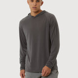 Man wearing a gray long-sleeve athletic shirt and shorts on a white background