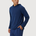 Man wearing a blue hoodie and shorts on a white background