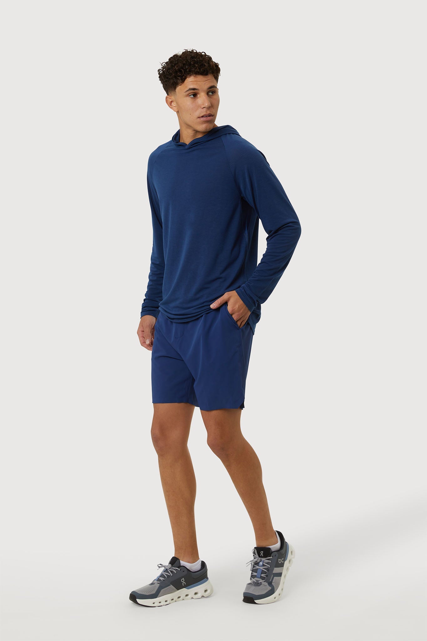 Man wearing a blue athletic outfit on a white background