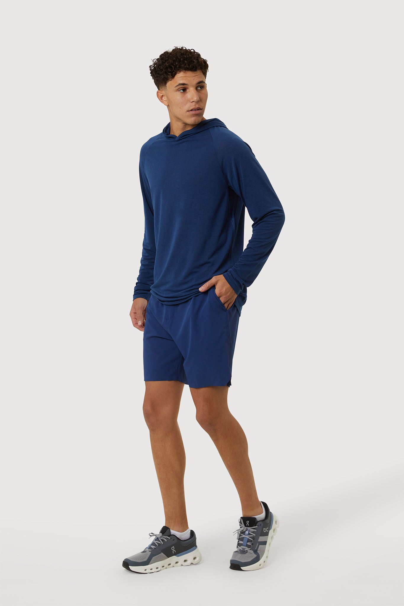 Man wearing a blue athletic outfit on a white background