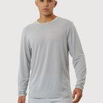 Man wearing a light gray long-sleeve shirt and shorts on a white background