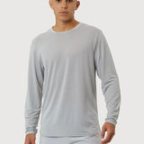 Man wearing a light gray long-sleeve shirt and shorts on a white background