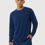 Man wearing a blue long-sleeve shirt and shorts on a white background