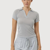 Woman wearing a gray short-sleeve top and shorts set on a white background