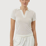 Woman wearing a white outfit on a plain background