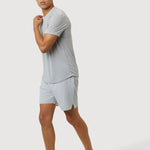 Man wearing a light gray t-shirt and shorts on a white background