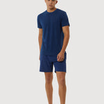 Person wearing a blue t-shirt and shorts set on a white background