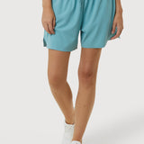 Person wearing light blue shorts on a white background