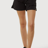 Person wearing black shorts on a white background