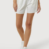 Person wearing white shorts on a plain background