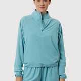 Woman wearing a light blue tracksuit on a white background