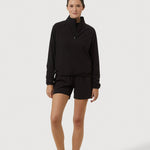 Person wearing a black outfit on a white background