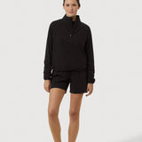 Person wearing a black outfit on a white background