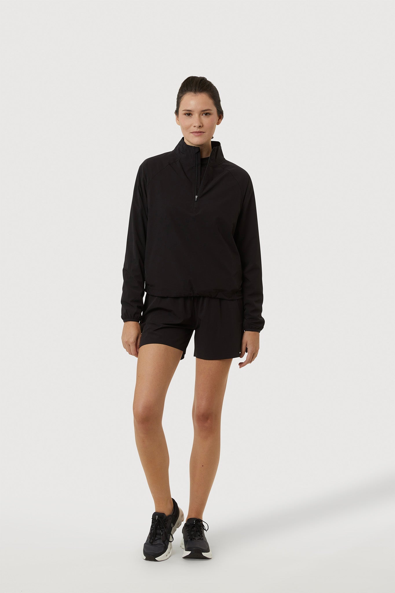 Person wearing a black outfit on a white background