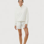 Person wearing a white outfit with shorts on a white background