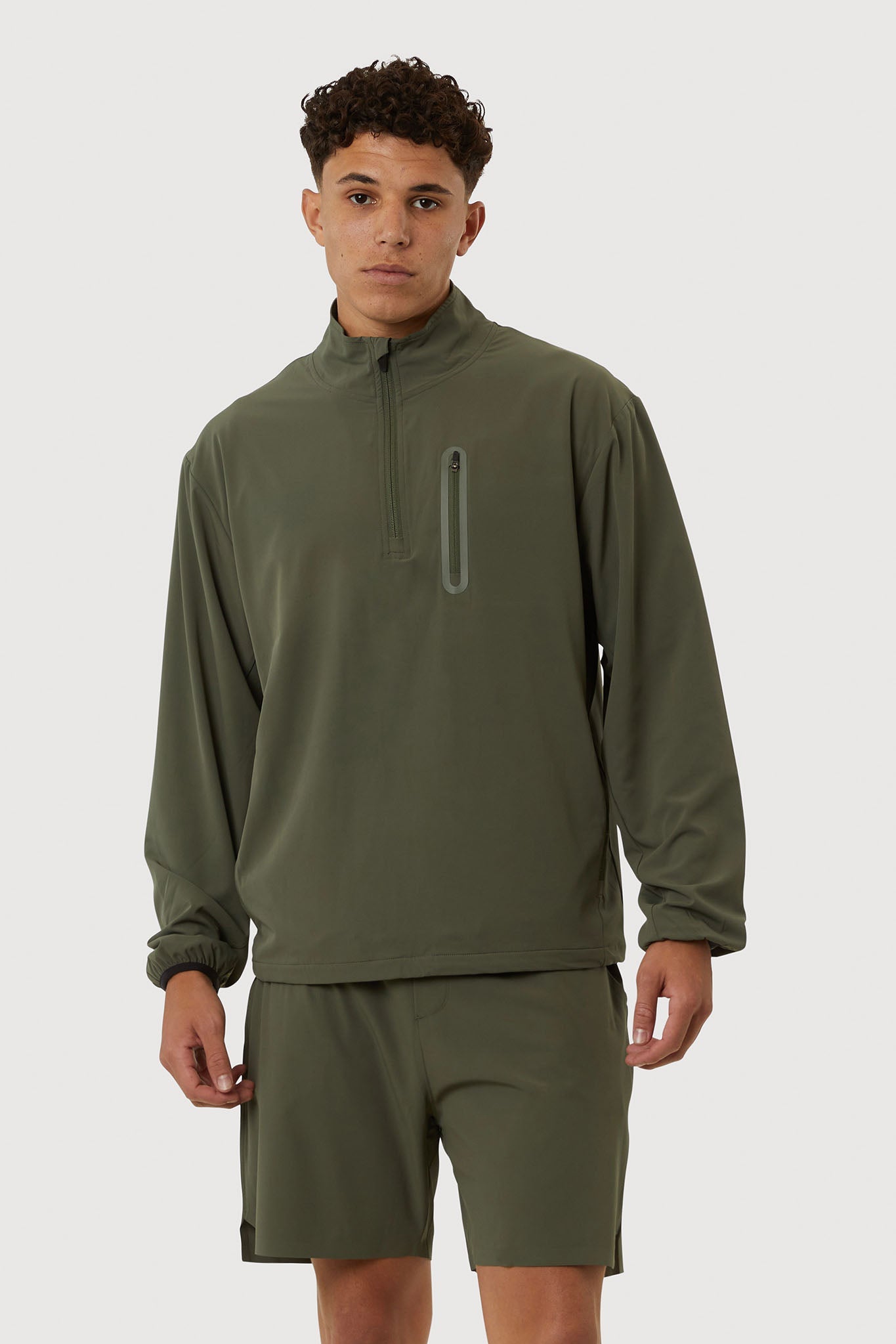 Person wearing a green athletic outfit on a white background