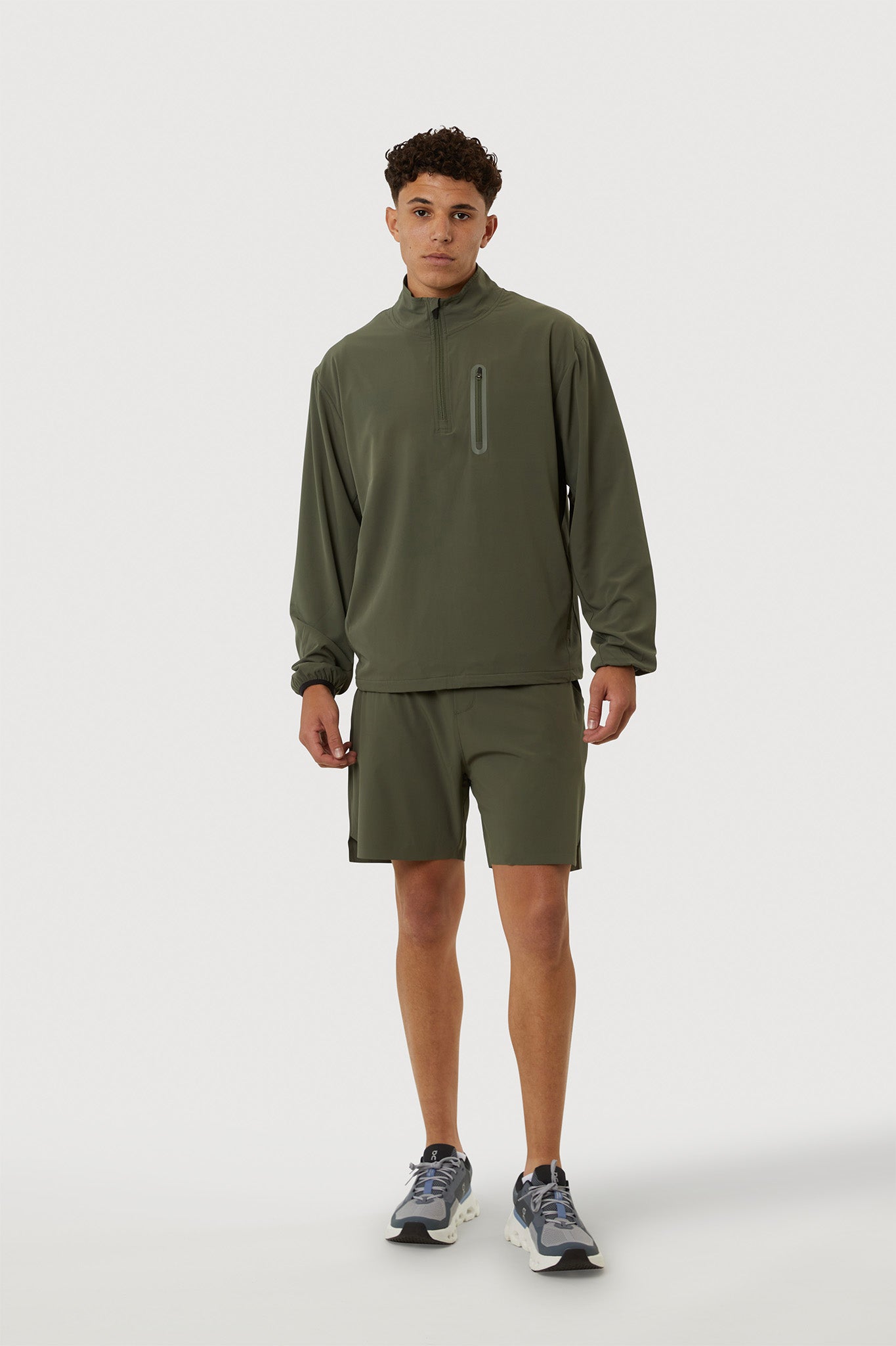 Person wearing a green athletic outfit on a white background