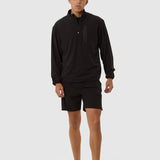 Person wearing a black long-sleeve athletic shirt and shorts on a white background