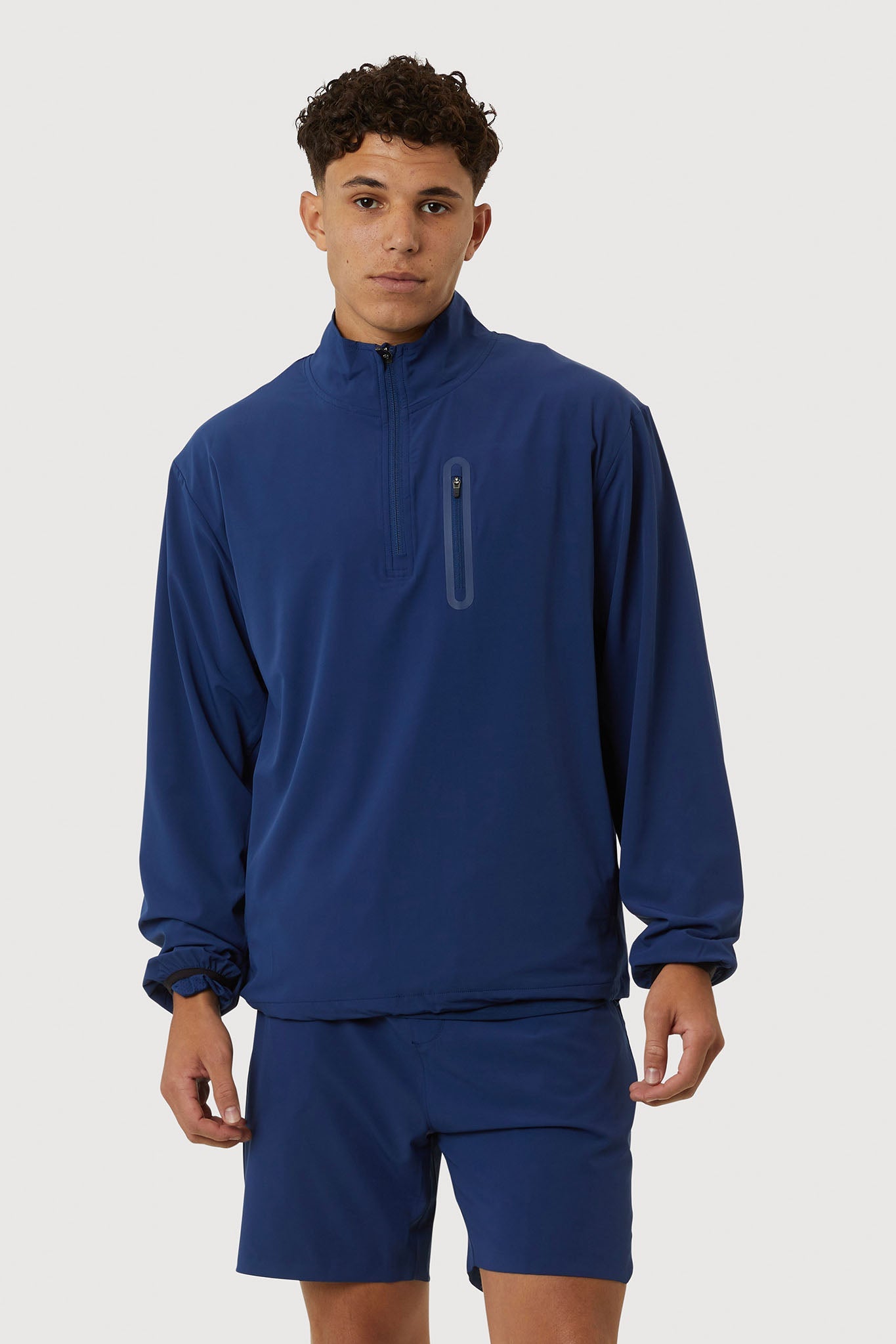 Person wearing a blue tracksuit on a white background
