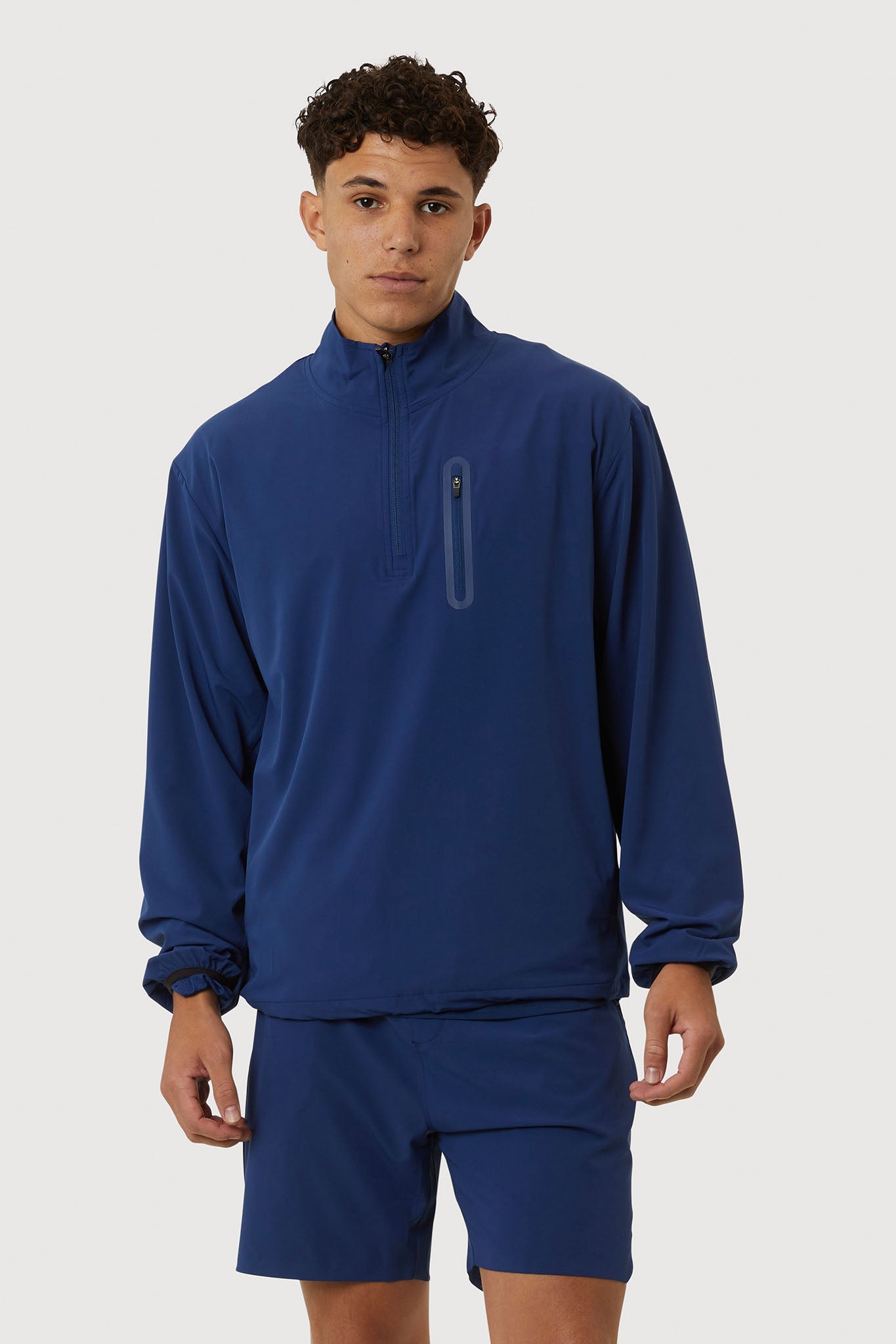 Person wearing a blue tracksuit on a white background