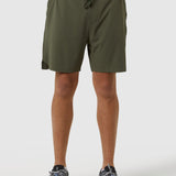 Person wearing olive green shorts on a white background