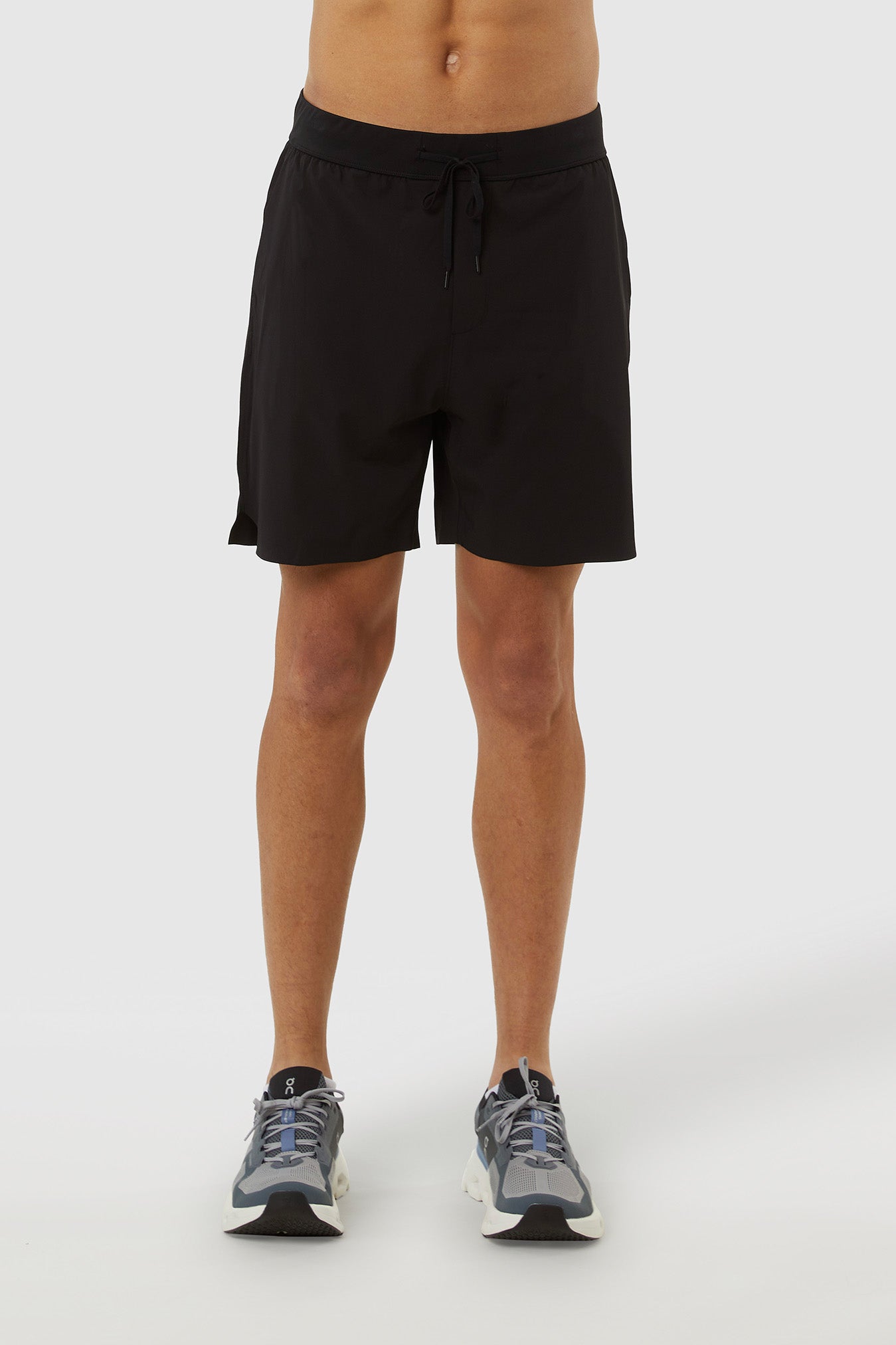 Person wearing black shorts on a white background