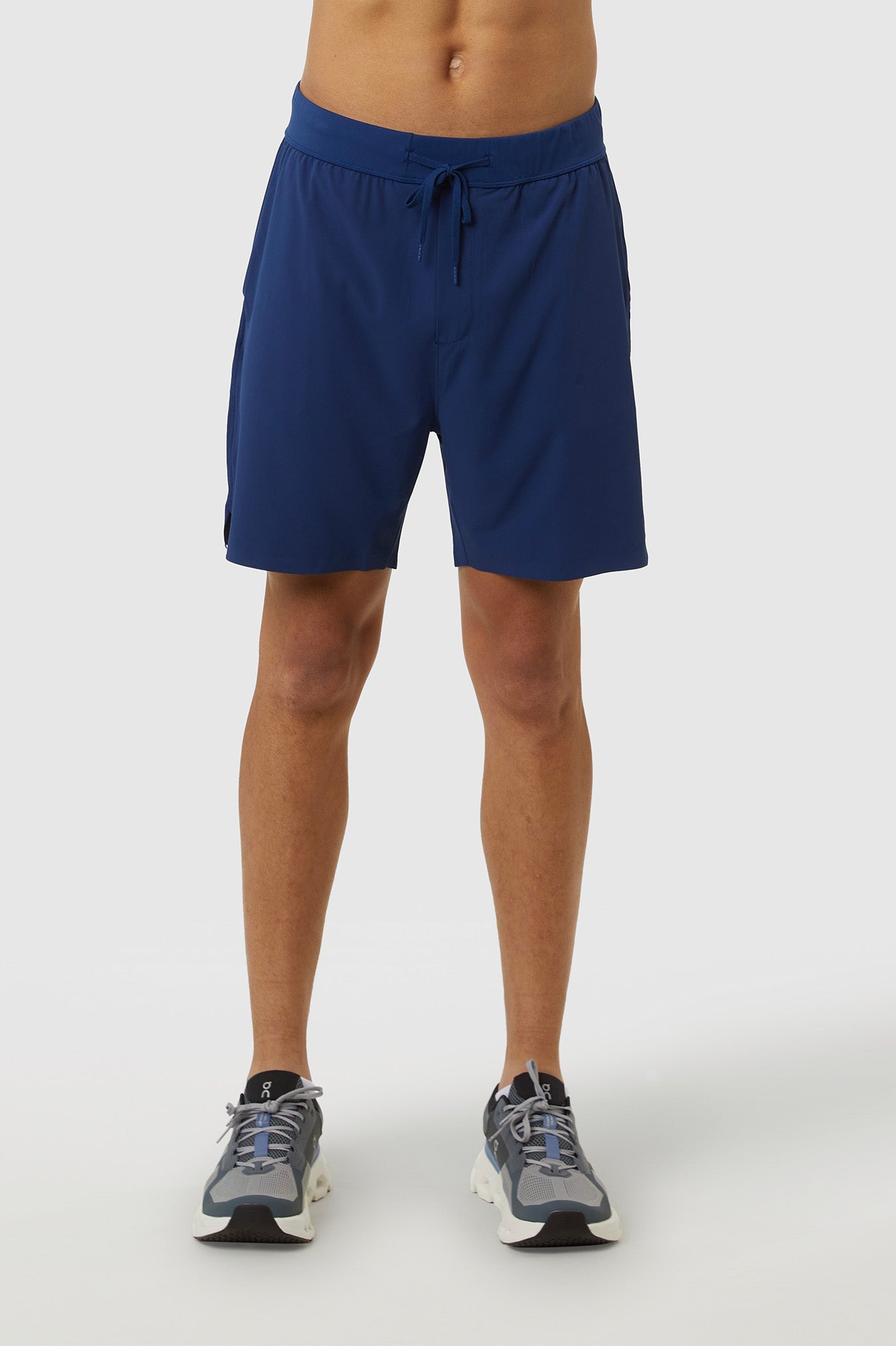 Person wearing blue shorts on a white background