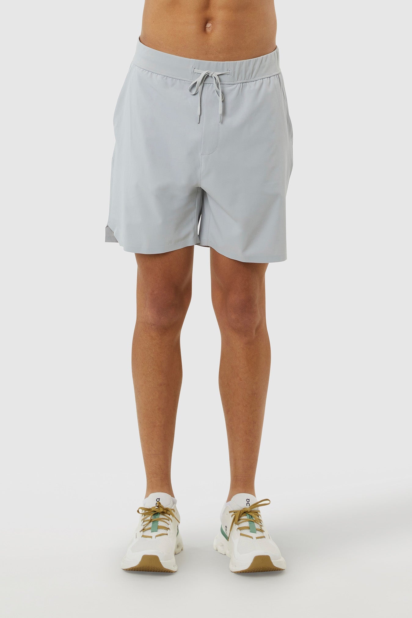 Light gray shorts worn by a person on a white background