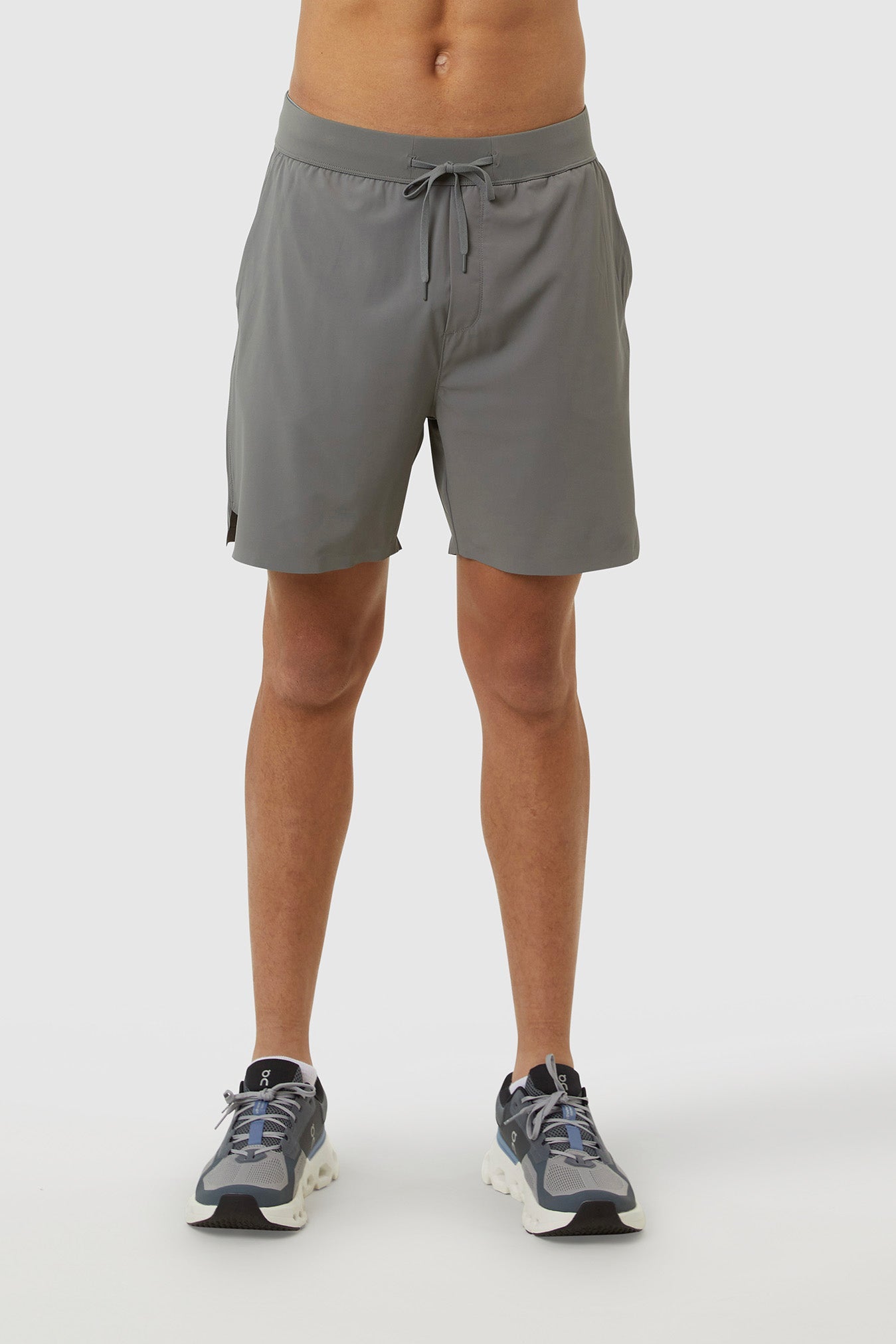 Person wearing gray shorts on a white background