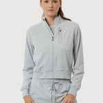 Woman wearing a light gray tracksuit on a white background