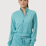 Woman wearing a teal tracksuit on a white background