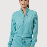 Woman wearing a teal tracksuit on a white background