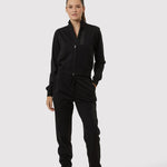 Person wearing a black tracksuit on a white background