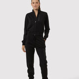 Person wearing a black tracksuit on a white background